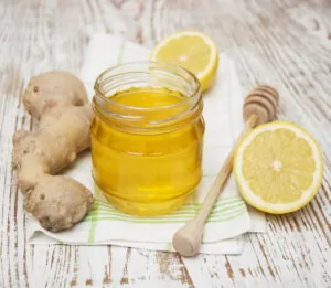 32704468 – honey,  lemon and ginger on a wooden background
